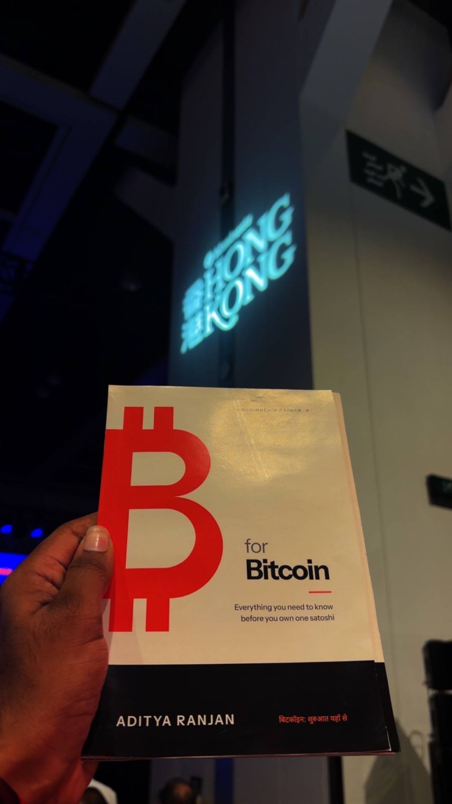 ₿ for Bitcoin book cover held up in Hong Kong